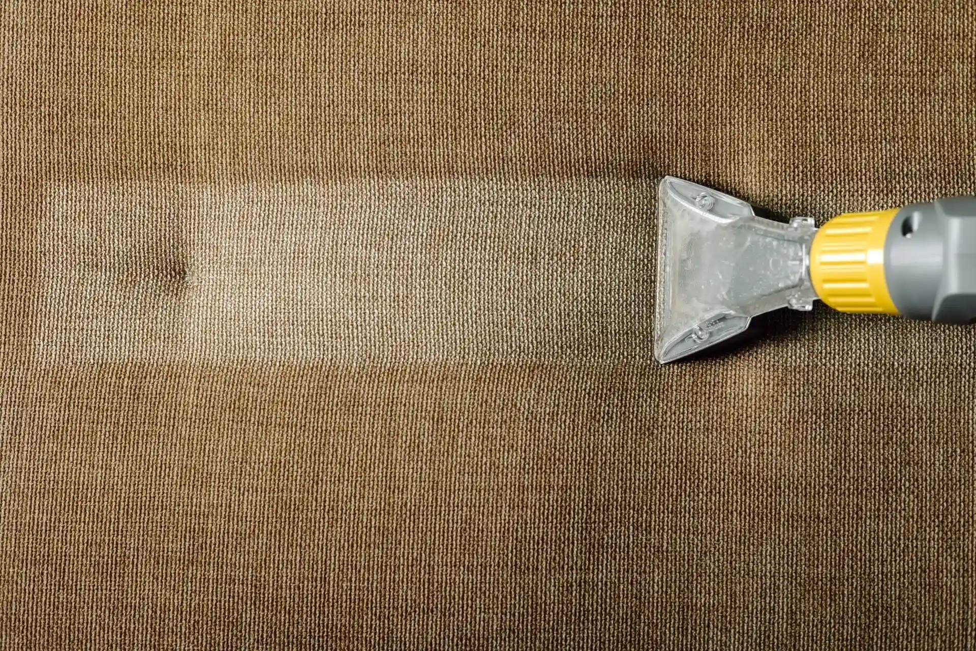 Upholstery cleaning wand extracting dirt from sofa fabric in Bryan College Station